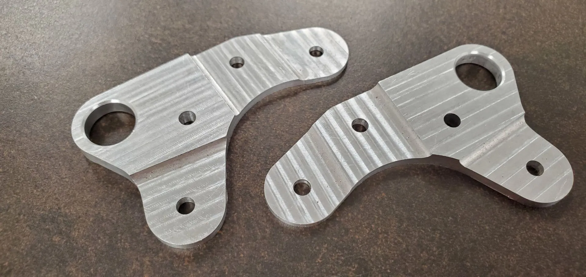 Aerospace brackets with precision-ground mating faces and controlled surface finish.