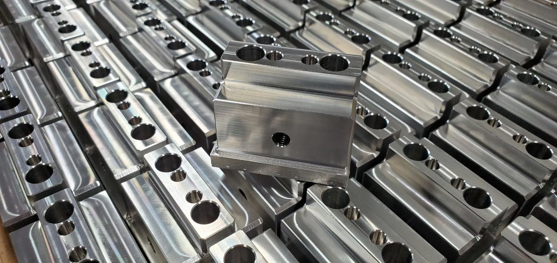 Precision-machined die plate with complex pocketing and located features.